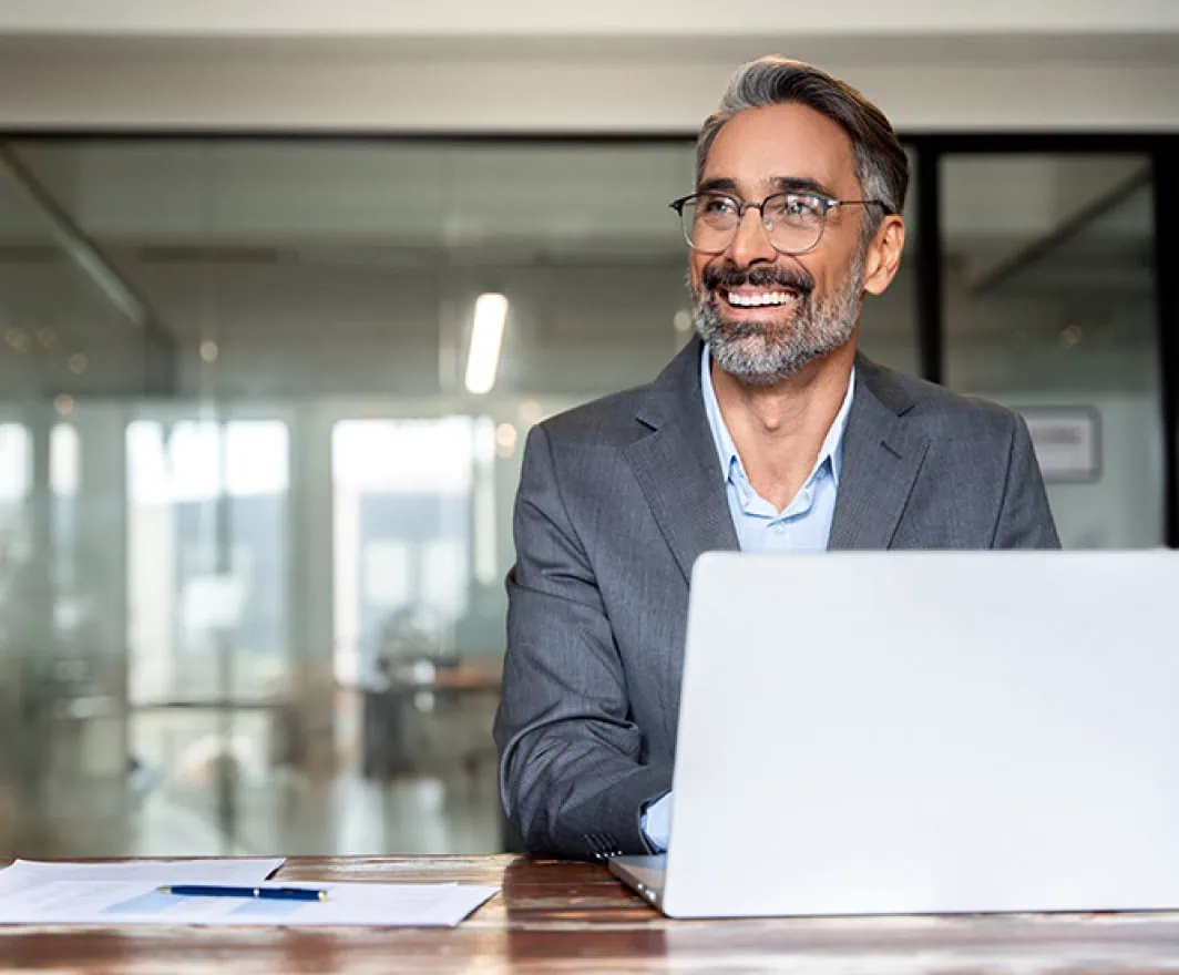 Man using laptop in conference room